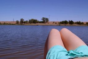 Legs on a river bank