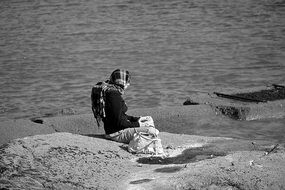 lonely woman meditates on the coast