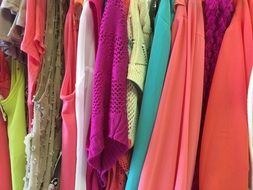 bright clothes on hangers in the store