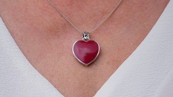 red pendant on a woman's neck