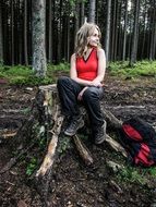 girl with a backpack in the forest