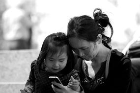 Mother and Daughter look in phone