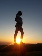 pregnant woman posing at colorful sunset