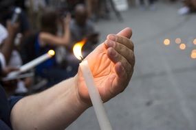 Hand holding a candle
