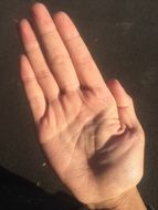 man's hand on a dark background