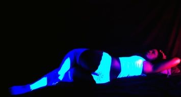 woman lies in the dark