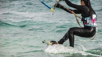 girl kitesurfing on the water