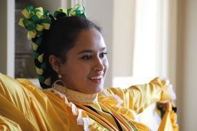 african woman in traditional yellow dress