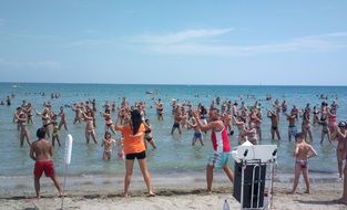 group of people dancing on the beach