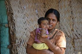 mom with baby in her arms in India