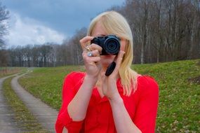 Blond woman with camera in a hands