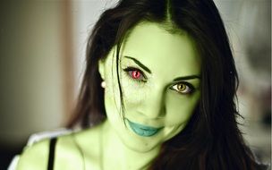 woman with colorful makeup in green filter