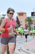 adult woman runs in competitions