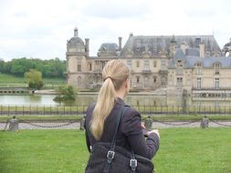 girl looks at the castle in paris