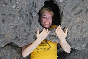 smiling woman among big stones