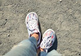 white sneakers on the girl's legs