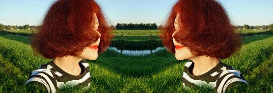 mirror portrait of a woman with red hair
