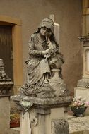 stone statue of a woman in a cemetery