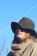 stylish woman in a raincoat and hat