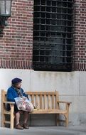 an old woman resting on a bench