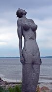 statue of a woman on the lakeside