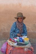 Woman Sales seeds and cigarettes on street