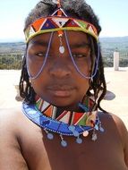 African girl is decorated with beads