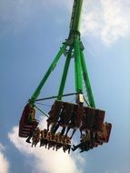 Fair Ride at blue sky background with white clouds