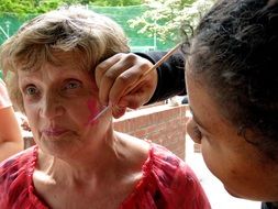 applying makeup to a woman