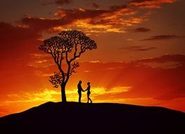 couple in love stands on a hill at sunset