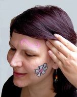 portrait of young woman's face with paintings on it