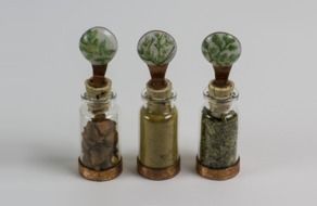sand bottles on a white surface