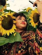 Woman taking photo with sun flowers