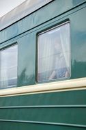 woman looking out the window of a compartment car