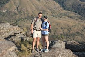 married couple standing on a cliff in south africa