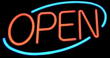 the sign "open" glows neon light