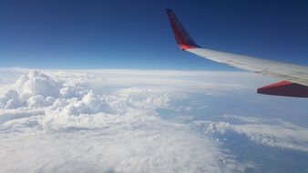 Plane in a flight on a cloudy sky