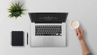 Laptop and coffee cup on a Working desk