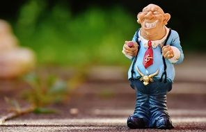 ceramic figurine of a man in the street