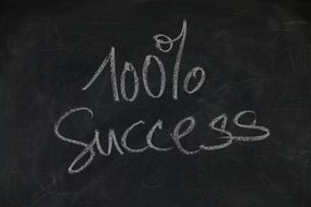 100 percent success sign on a blackboard