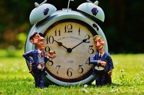 ceramic figurines of businessmen near the clock