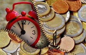 coins and alarm clock