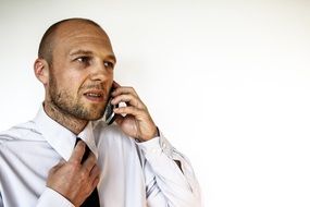 Businessman in white Shirt and black Tie talking on cell phone