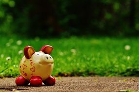 ceramic pig on the path near the green grass