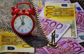 banknotes and alarm clock