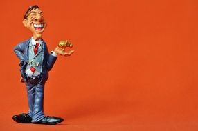 figurine of a happy businessman on an orange background