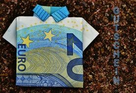 folded euro banknote on brown background