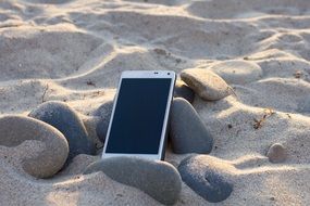 phone on the sand on the beach