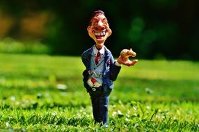 figurine of a happy businessman in the street