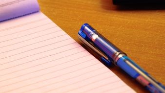 Notepad and blue pen